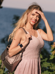 Hippie woman with backpack walking outdoor