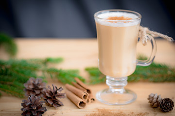 Chocolate Martini Cocktail or eggnog with cinnamon and chocolate in glass for Christmas on mahogany background. Homemade festive cocktail for winter holidays.Close up.