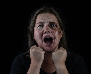 Angry young woman victim of domestic violence and abuse having nervous breakdown screaming....
