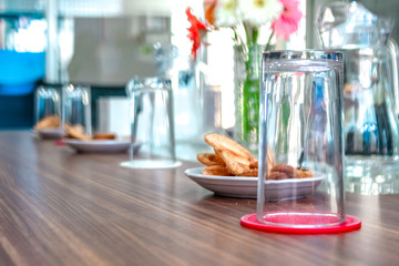 Business people sitting on a table for conference with cookies glass and jar of water placed on wooden table