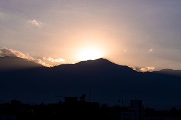 Sunset in the mountains, Twilight and golden hour. Sun rays bursting out of mountains