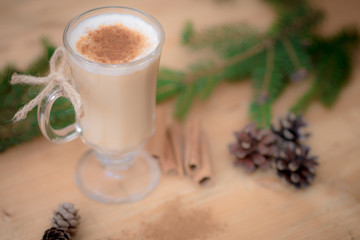 Chocolate Martini Cocktail or eggnog with cinnamon and chocolate in glass for Christmas on mahogany background. Homemade festive cocktail for winter holidays.Close up.