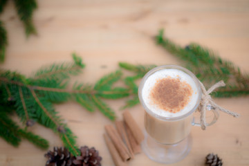Chocolate Martini Cocktail or eggnog with cinnamon and chocolate in glass for Christmas on mahogany background. Homemade festive cocktail for winter holidays.Close up.
