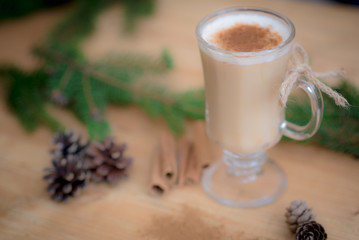 Chocolate Martini Cocktail or eggnog with cinnamon and chocolate in glass for Christmas on mahogany background. Homemade festive cocktail for winter holidays.Close up.