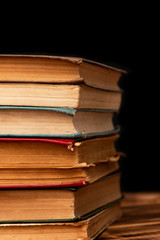 stack of old books on a black background