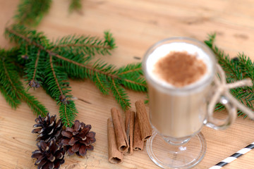 Chocolate Martini Cocktail or eggnog with cinnamon and chocolate in glass for Christmas on mahogany background. Homemade festive cocktail for winter holidays.Close up.
