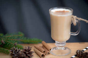 Chocolate Martini Cocktail or eggnog with cinnamon and chocolate in glass for Christmas on mahogany background. Homemade festive cocktail for winter holidays.Close up.