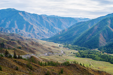 Fototapeta na wymiar Serpentine mountain road. View of the Chuysky tract from the Chike-Taman pass, Altai mountains, Russia