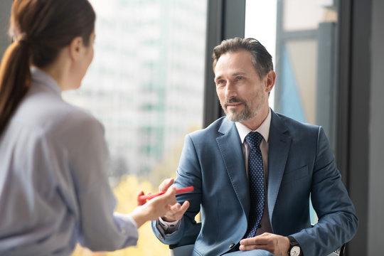 Affluent entrepreneur speaking with journalist while giving interview