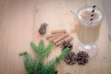 Chocolate Martini Cocktail or eggnog with cinnamon and chocolate in glass for Christmas on mahogany background. Homemade festive cocktail for winter holidays.Close up.