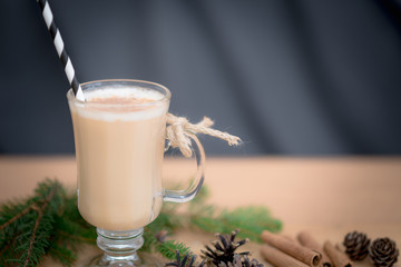 Chocolate Martini Cocktail or eggnog with cinnamon and chocolate in glass for Christmas on mahogany background. Homemade festive cocktail for winter holidays.Close up.