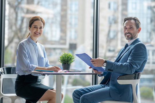 Couple of businessmen smiling after creating new business plan for next year