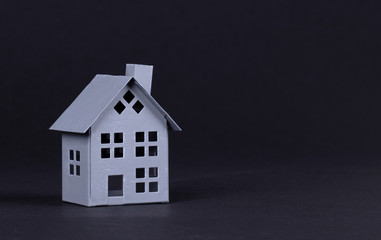 Estate concept, metal house on isolated on black background