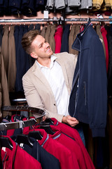 Man choosing new coat