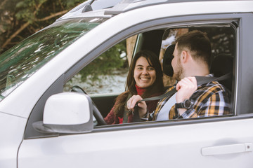 couple inside car talking ready for road trip