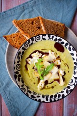 Homemade brocolli cream soup with goat cheese and parmesan and toast