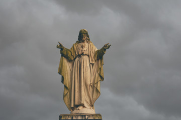 Lord Jesus statue in a cloudy weather outside a Church