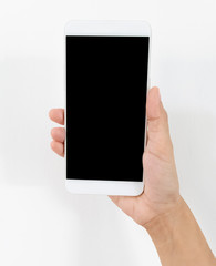 Female hand holding a white cell phone with a black screen at an isolated background.