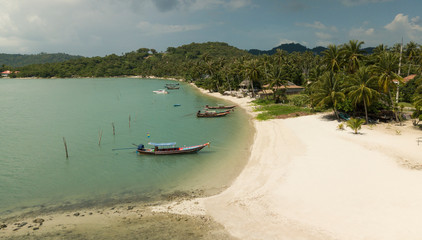 Aerila drone scene of sandy clean beach and fishing boats - Koh Samui - Thailand