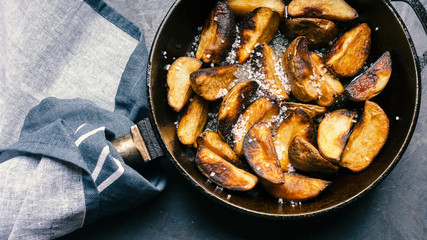 Fried potatoes in a cast-iron skillet. Macro shot.