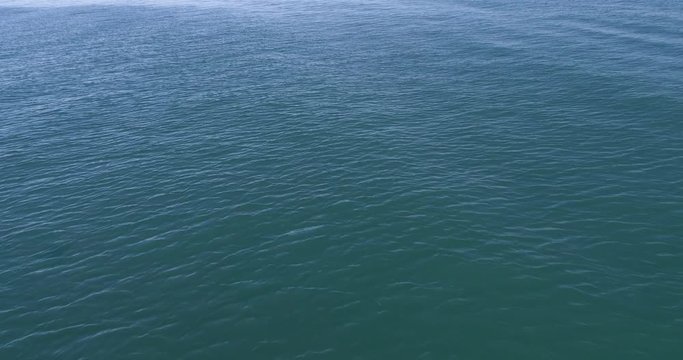 Close up of the calm blue water of a sea, ocean