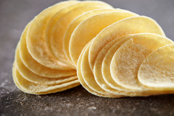 Potato chips on stone table 