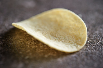 Potato chips on stone table 