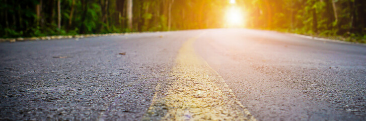 Banner size,The road in the morning forest with sunshine at the destination