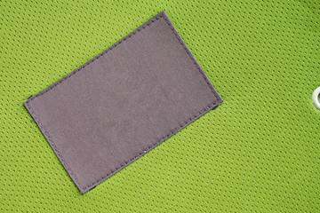 Fototapeta premium laundry care clothing label patch on polyester fabric jersey sport texture