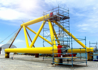 Oil rig platform during construction site in the harbor yard and workers preparing to move into the vessel to be installed in offshore locations.  - image Film grain effect