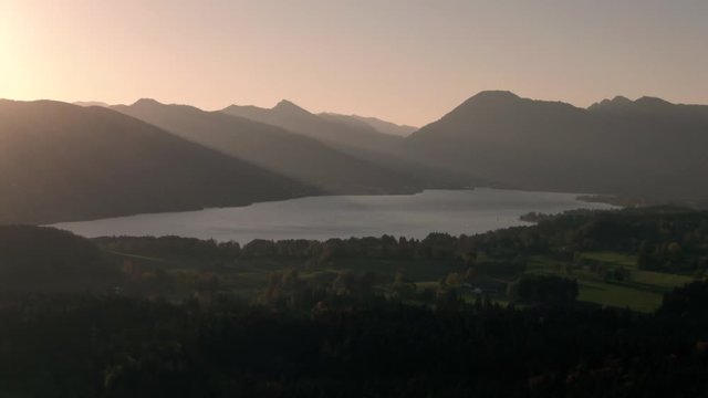 Aerial view of Chiemsee lake bavaria sunrise over the mountains with beatiful lensflare