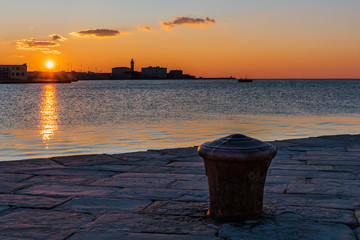 Sunset from the Audace pier of Trieste. Colors of fire on the water. Italy
