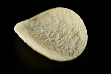 Potato chip on black background 