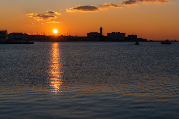 Sunset from the Audace pier of Trieste. Colors of fire on the water. Italy