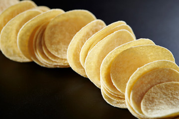 Potato chip on black background 