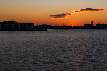 Naklejka premium Sunset from the Audace pier of Trieste. Colors of fire on the water. Italy