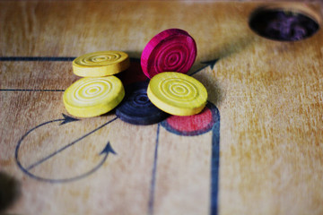 A game of carrom with pieces carrom man on the board carom - stacking.A game of carom set and ready...
