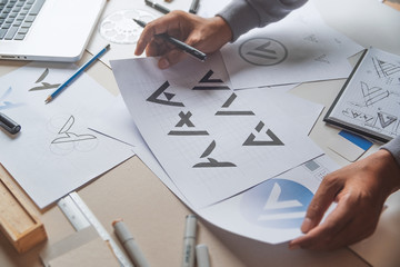Graphic designer drawing sketch design creative Ideas draft Logo product trademark label brand...