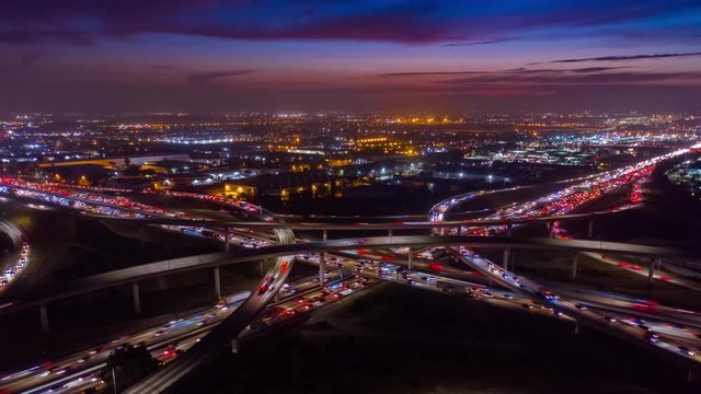 Urban aerial time lapse of busy freeway at night with heavy traffic.