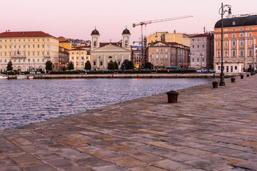 Sunset from the Audace pier of Trieste. Colors of fire on the water. Italy