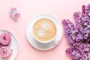 Lilac, cup of coffee, homemade marshmallow, notepad on pink background. Still life. Spring romantic mood. Top view. Copy space - Image