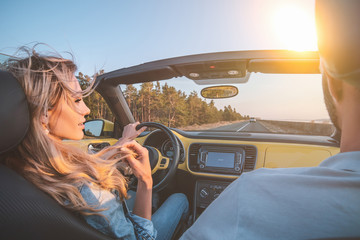 The young couple traveling by a cabriolet