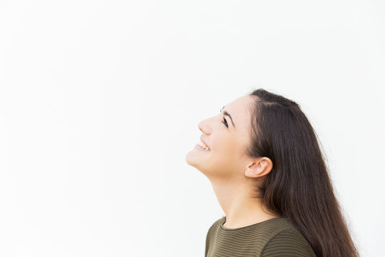 Head of happy beautiful woman looking up at copy space, smiling, laughing. Young woman in casual standing isolated over white background. Advertising concept