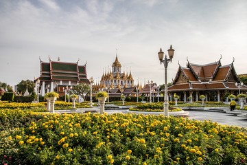 Wat Ratchanatdaram Woravihara (Loha Prasat) with yellow flowers during coronation celebrations of...