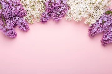  Branches of lilac on pink background. White and purple lilac. Romantic spring mood. Top view. Copy for your text - Image © lizaelesina