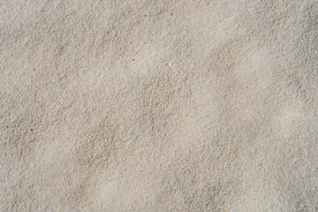 Fototapeta na wymiar Sand texture background, natural sand at a soft white beach