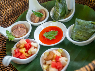 Mixed meat diet and dessert decorated in one piece lay on rattan tray in Thai style serving