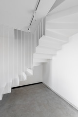 Architectural interior fragment of the white room corner and modern metal staircase