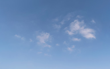 Naklejka na ściany i meble abstract cloudscape of small wispy puffy clouds in a clear blue sky with a little haze at the bottom