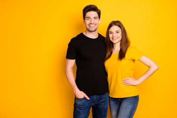 Photo of cheerful positive nice cute pretty couple hugging with man holding hand in jeans denim pocket smiling toothily isolated over vivid color background